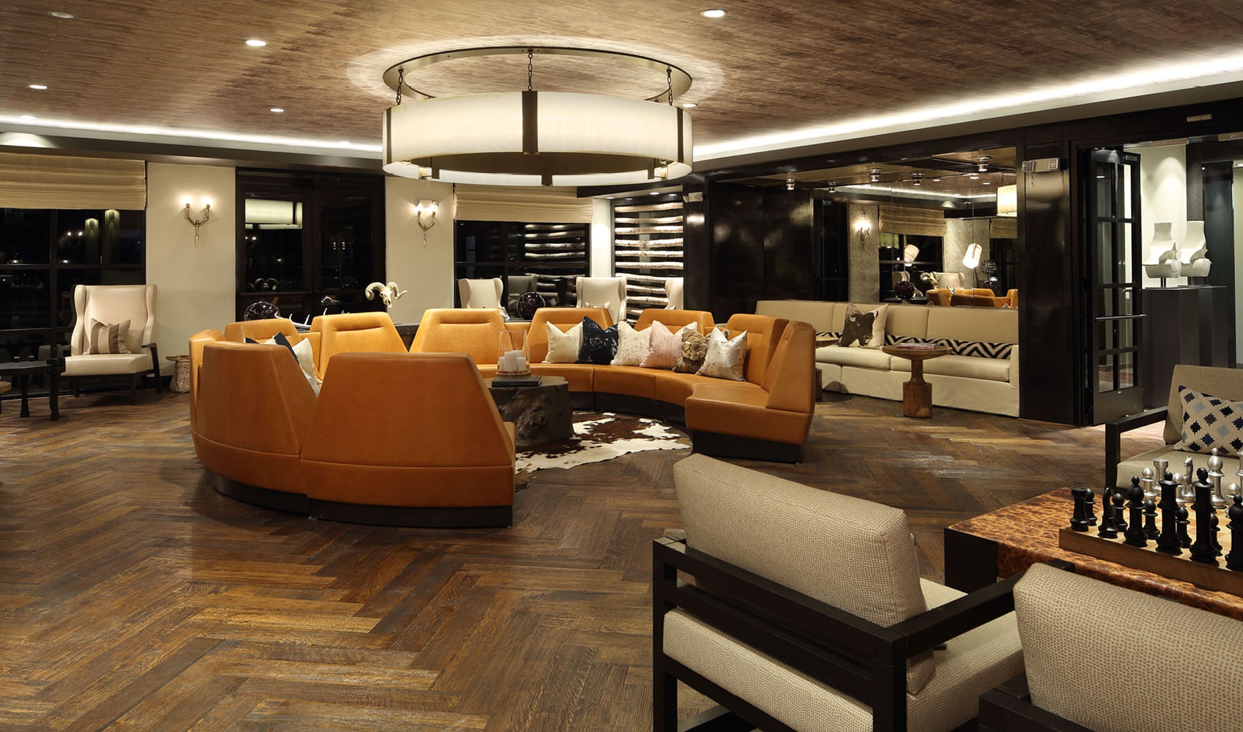 well lit clubhouse lounge with social seating areas and game tables